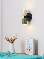 Wall lamp with metal shade lighting a room corner