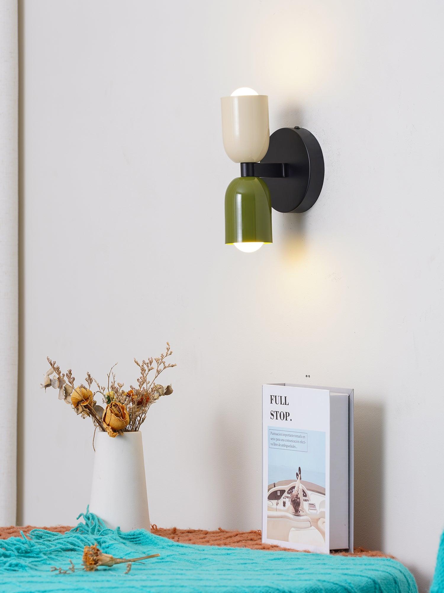 Wall lamp with metal shade lighting a room corner