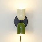 Up and down wall lamp adding soft light to a styled space