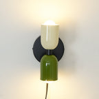 Coloured shade wall lamp glowing warmly in an interior