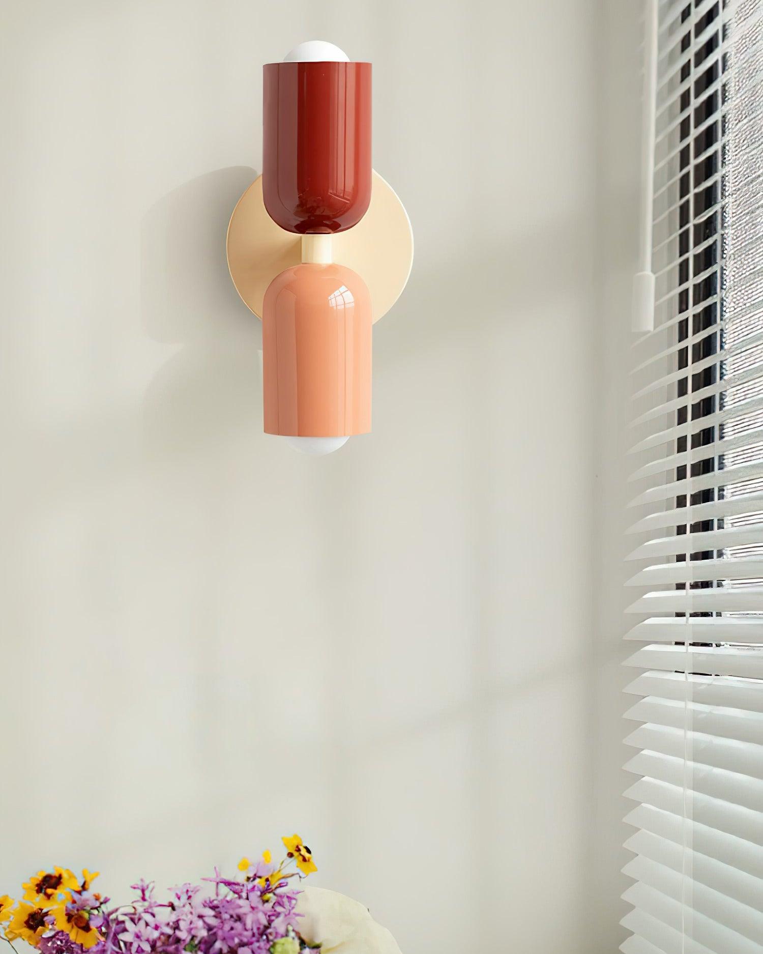 Coloured wall lamp glowing warmly in a styled space