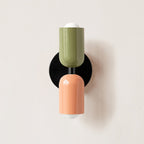 Coloured metal wall lamp in a styled interior setting