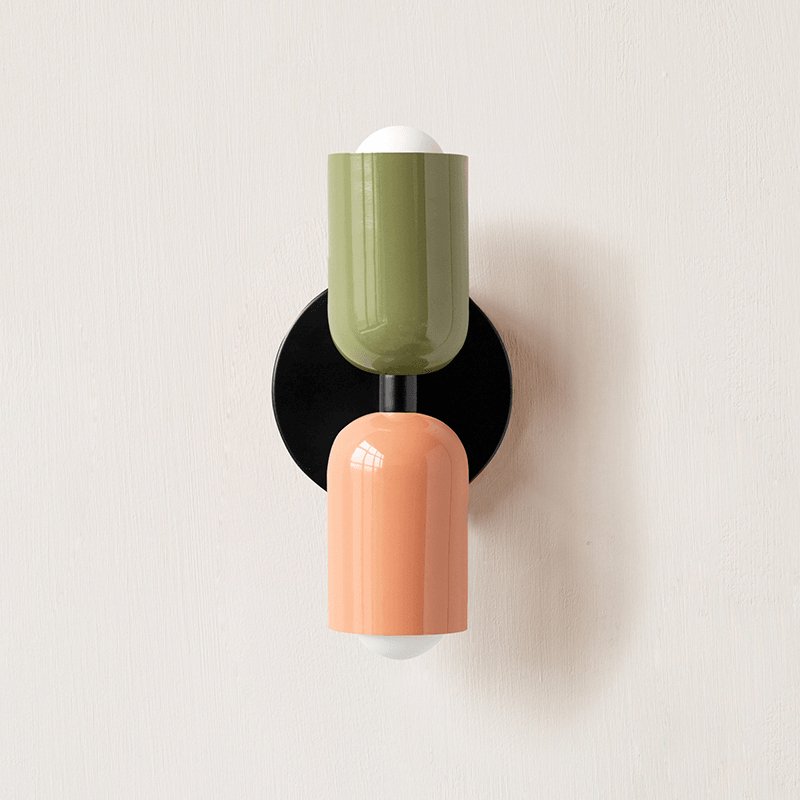 Coloured metal wall lamp in a styled interior setting