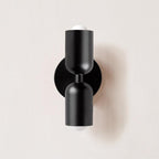 Wall lamp glowing warmly in a styled room corner