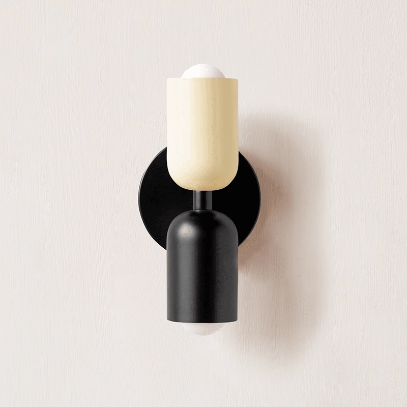 Wall lamp glowing softly against a neutral wall