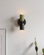 Wall lamp casting warm light beside a wall surface