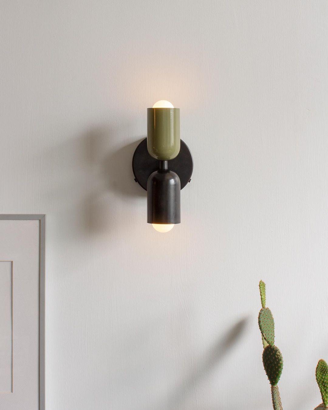 Wall lamp casting warm light beside a wall surface