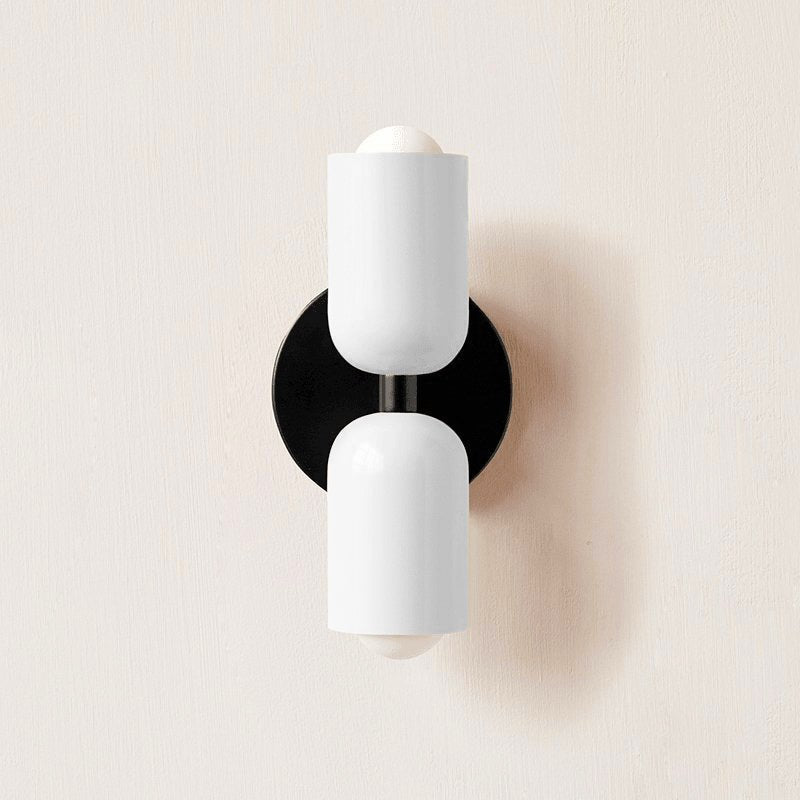 Black metal wall lamp shown against a plain background