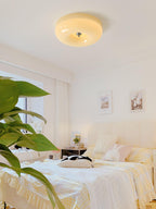 Cream Pudding ceiling light glowing warm in an interior