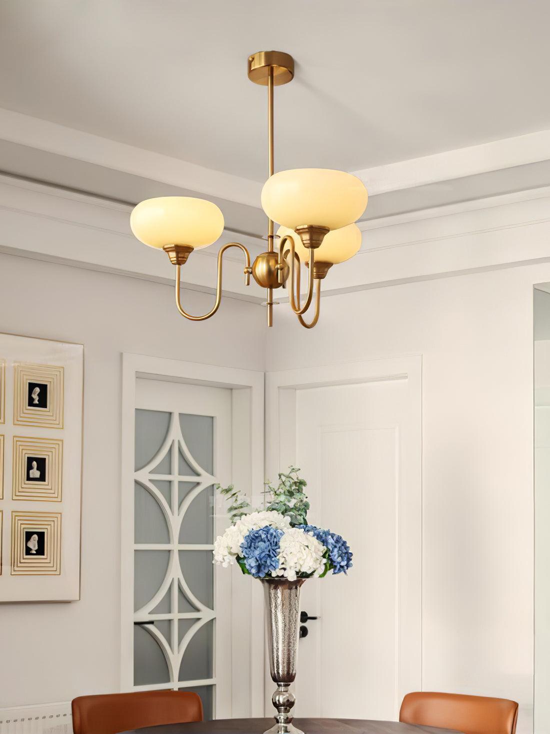 Persimmon chandelier shown from a lower angle, glass lit