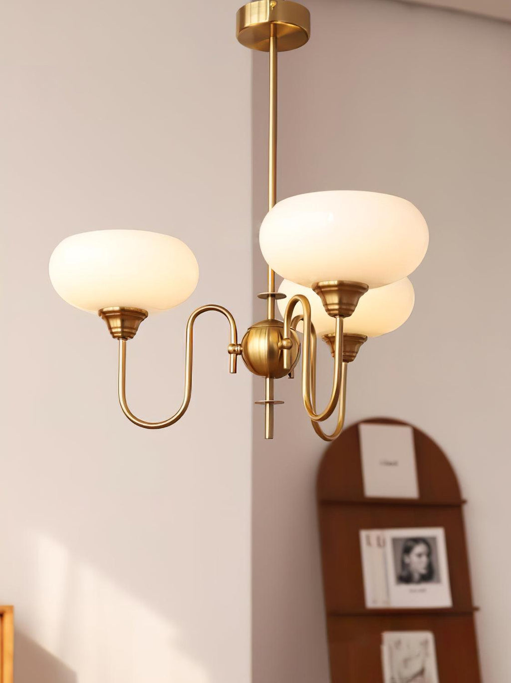 Persimmon chandelier with creamy glass cluster glowing softly