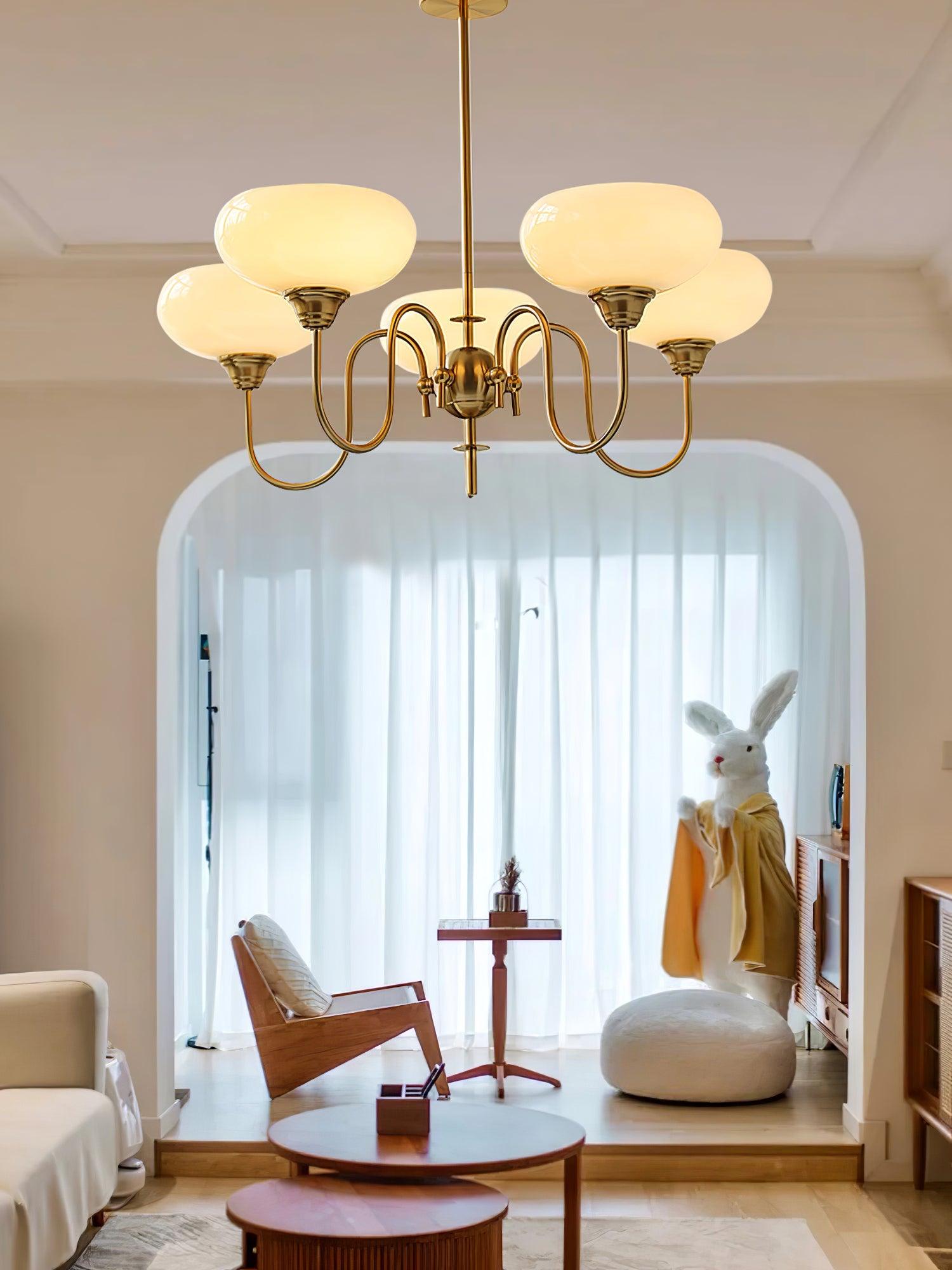Persimmon chandelier with gold finish and creamy yellow shades