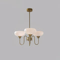 Persimmon chandelier with creamy glass globes lit in a warm interior