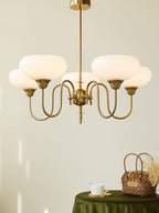Persimmon chandelier glowing over a dining setting