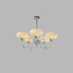 Persimmon chandelier lit against a soft neutral backdrop