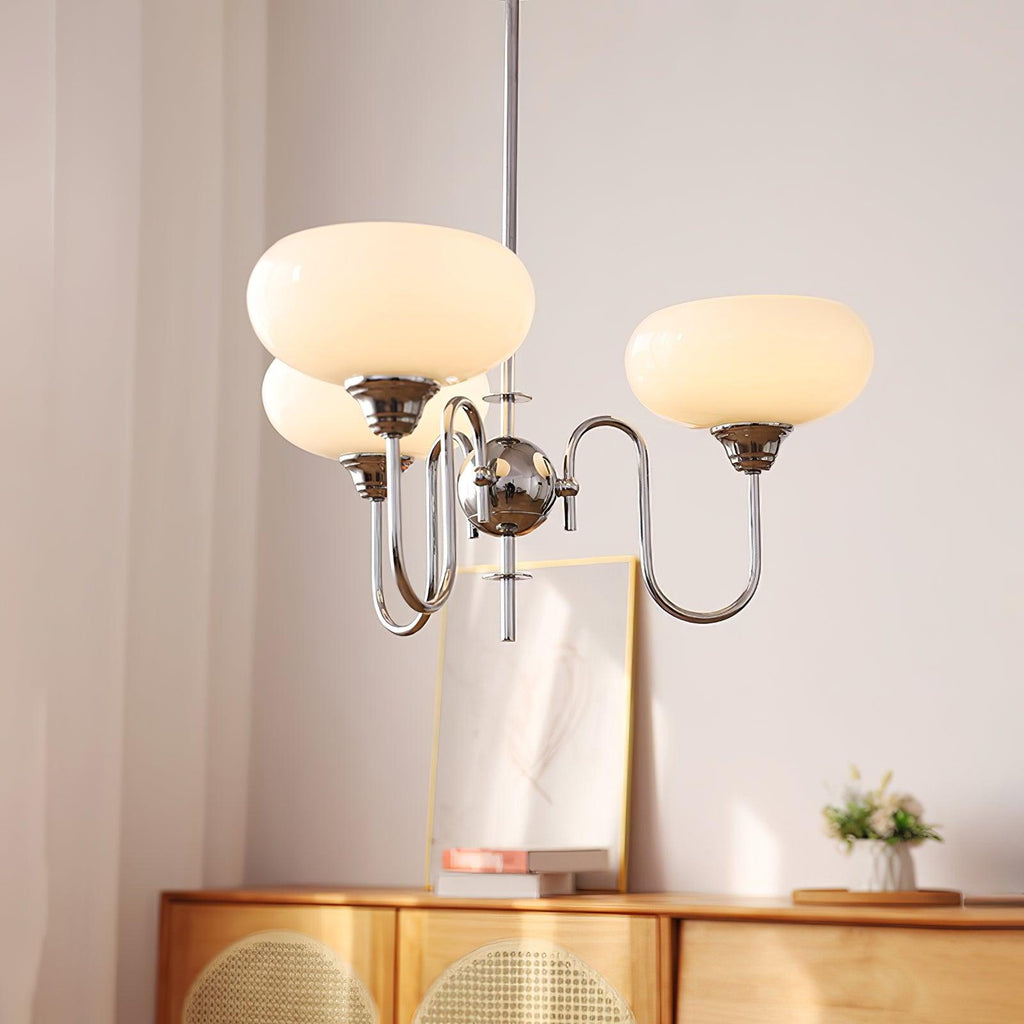 Persimmon chandelier with layered glass globes glowing warm