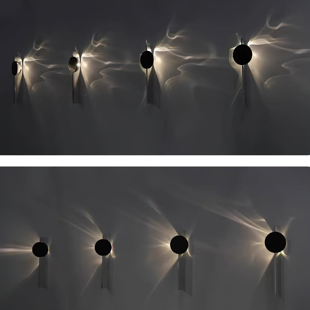 Mirrored chrome wall lamp throwing dramatic shadow lines
