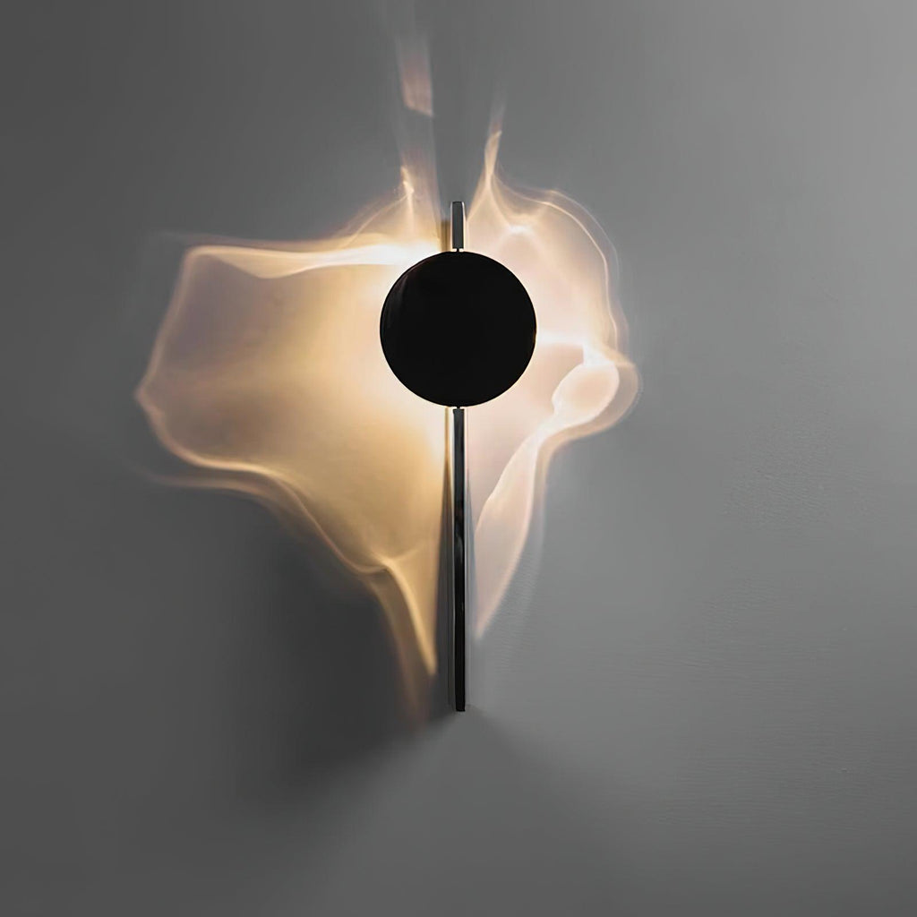 Mirrored wall lamp reflecting light across a textured surface