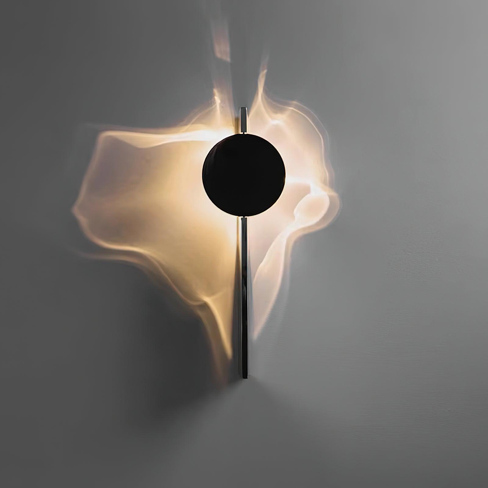 Mirrored wall lamp reflecting light across a textured surface