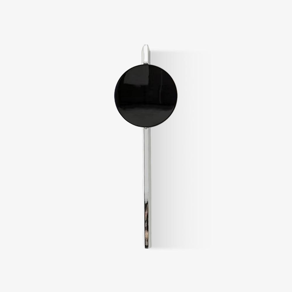Mirrored chrome wall lamp throwing a play of refracted light