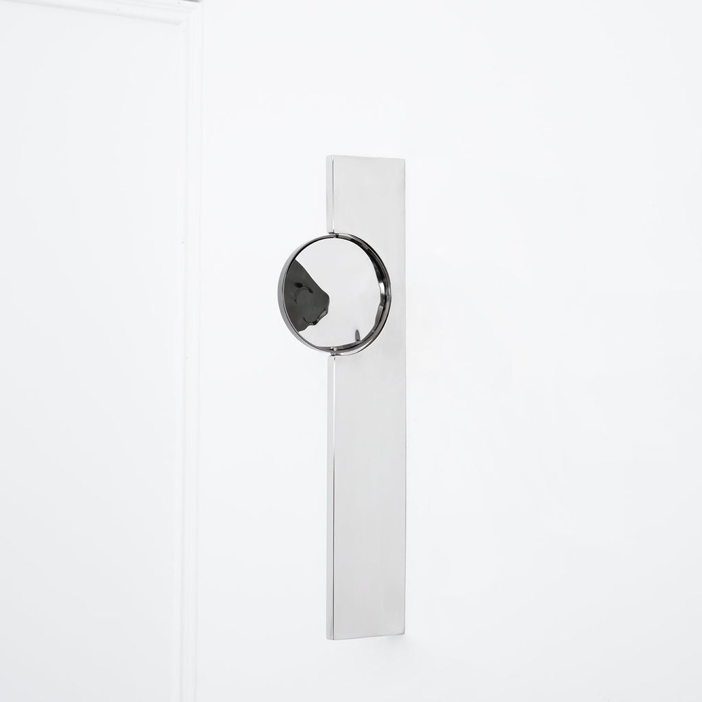 Polished chrome wall lamp with a moving play of shadow