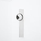 Polished chrome wall lamp with a moving play of shadow