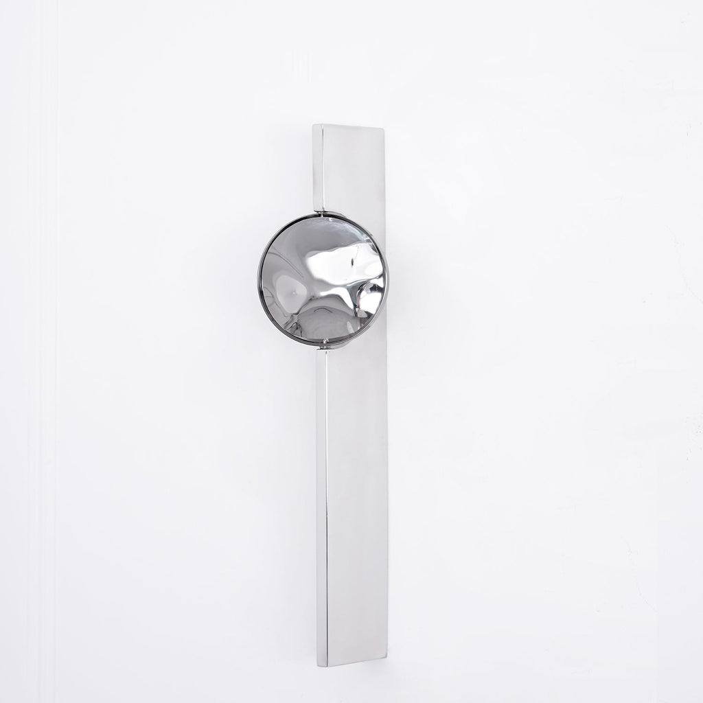 Slim chrome wall lamp with integrated LED in a dim setting