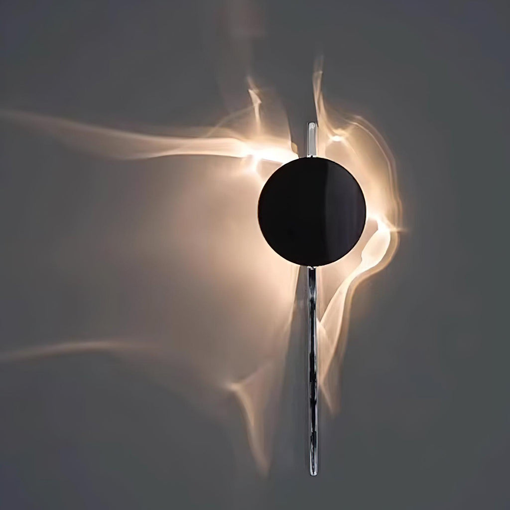 Chrome light-and-shadow wall lamp shown in a dim interior
