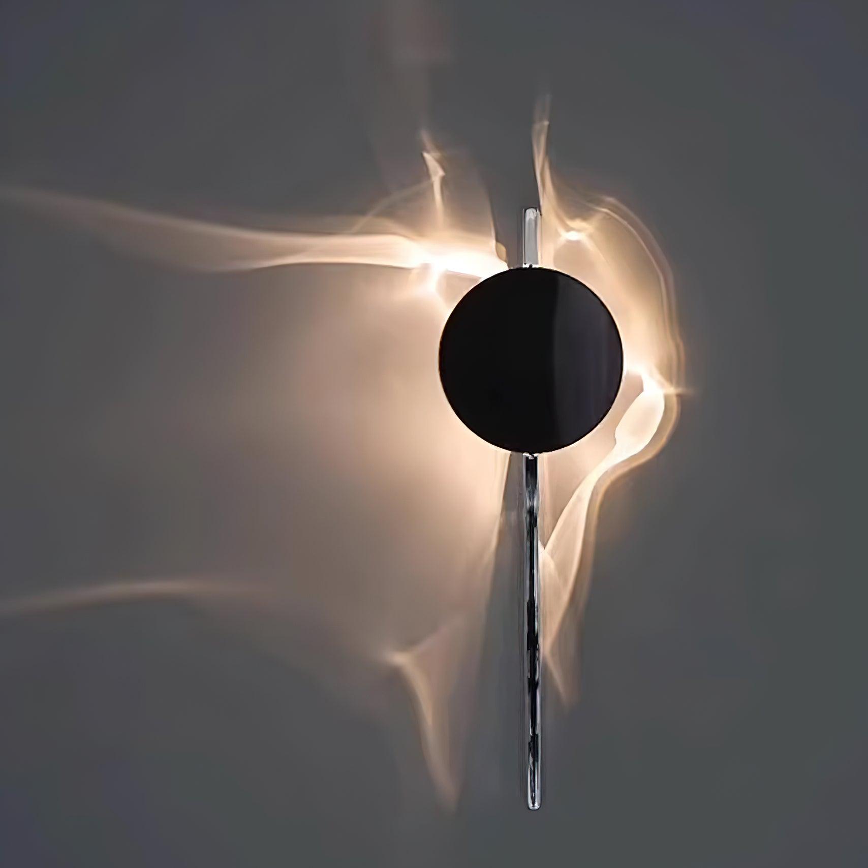 Chrome light-and-shadow wall lamp shown in a dim interior