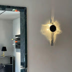 Chrome wall lamp casting soft light and shadow over a corner