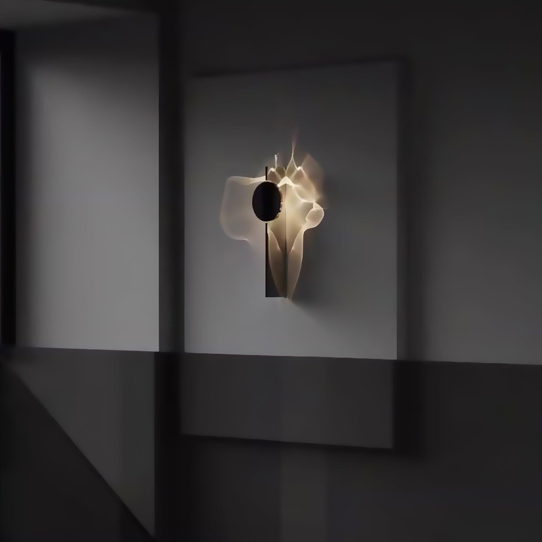 Mirrored chrome wall lamp shown close up with black shade