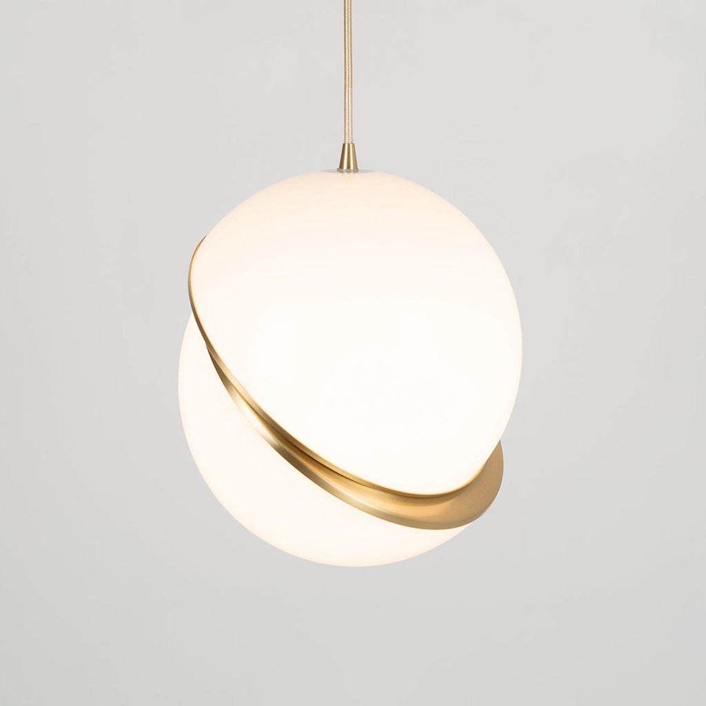 Hanging low with extra cord showing above, this Clérachic pendant glows softly against a plain grey backdrop.
