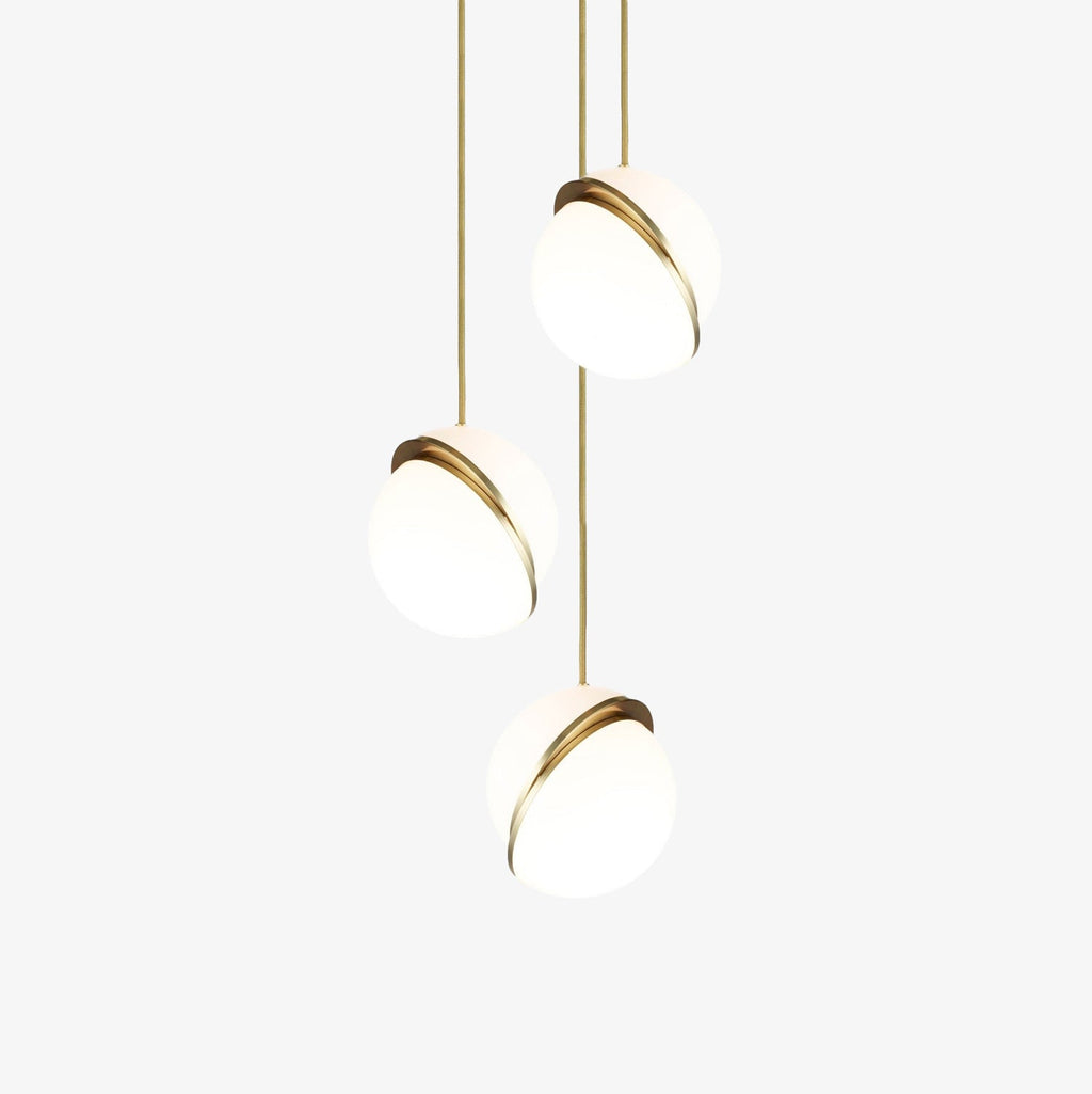 On a plain white backdrop, three brass-crescent pendants of this Clérachic fixture cluster on slender cords.