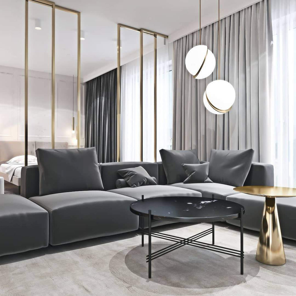 Beside sheer curtains above a grey sectional sofa and marble coffee table, two of this Clérachic pendant hang.