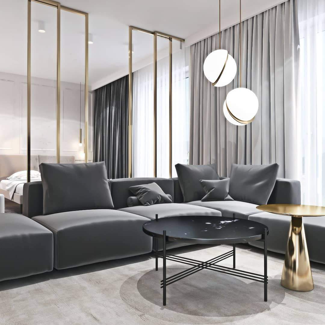 Beside sheer curtains above a grey sectional sofa and marble coffee table, two of this Clérachic pendant hang.
