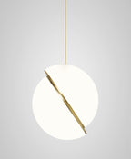 Photographed at a steep angle, this Clérachic pendant's brass crescent cuts diagonally across the sphere.
