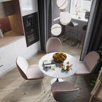 Over a round table and pink chairs in an open-plan kitchen, pendants of this Clérachic fixture hang.