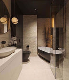 Beside a dark stone bathroom with a freestanding tub, two of this Clérachic pendant hang.