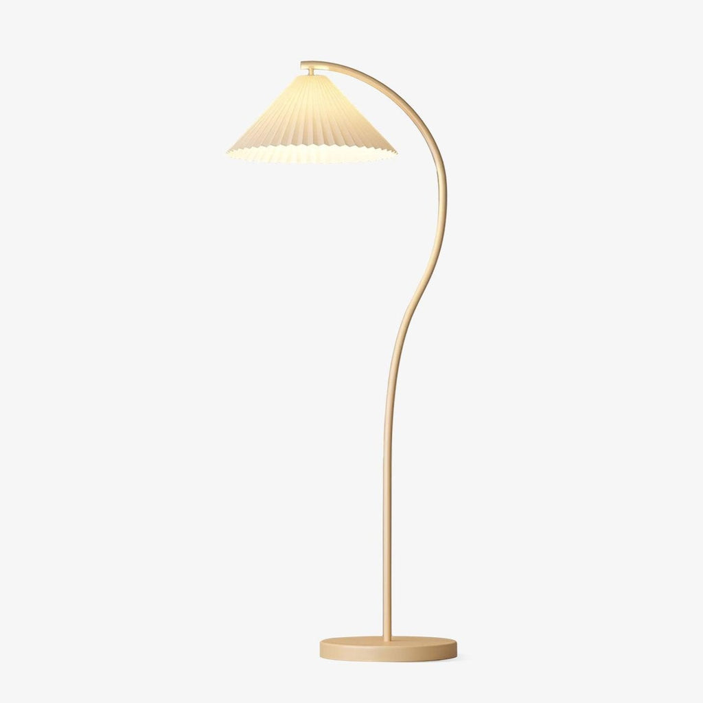 Pleated linen floor lamp with a beech wood frame lighting a styled living room