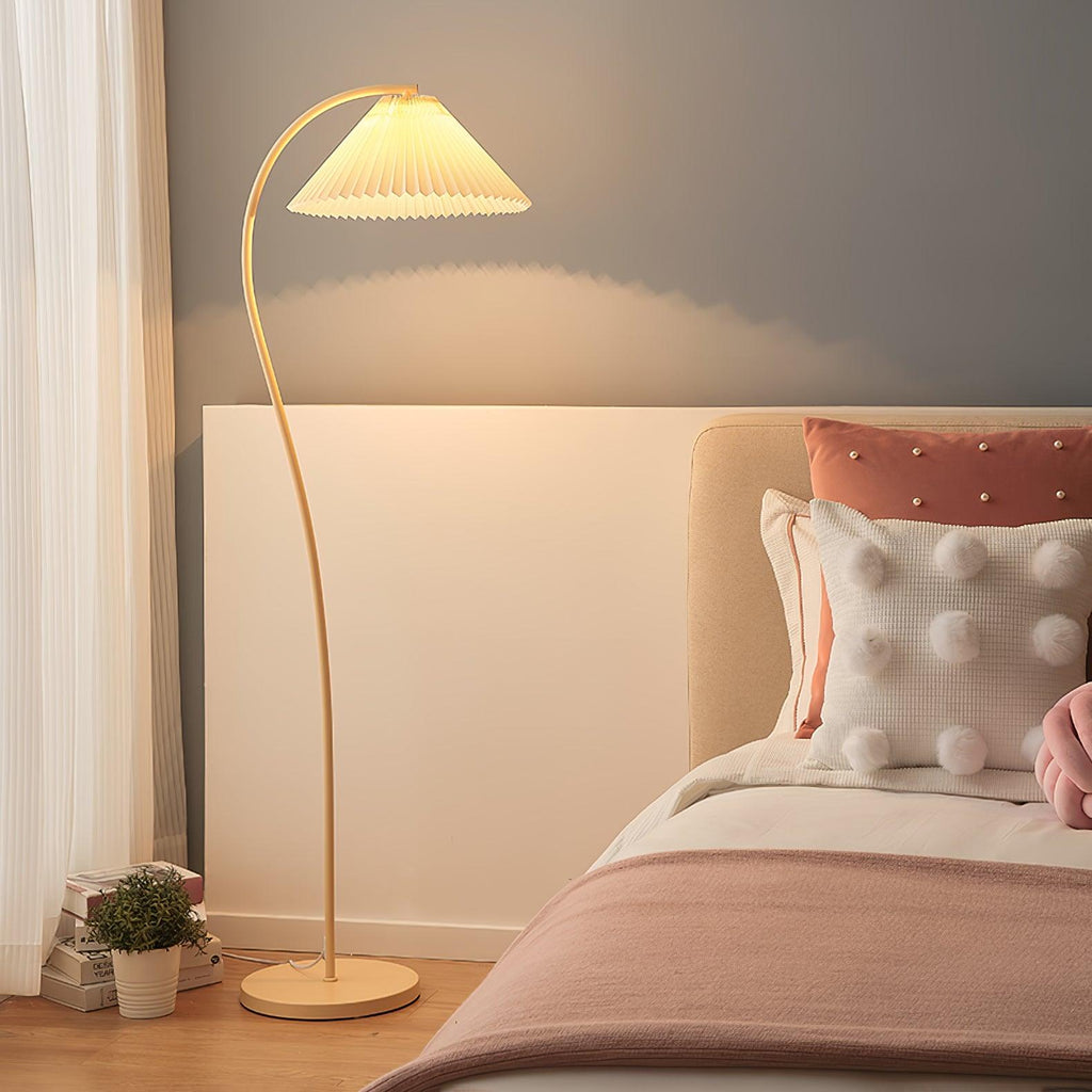 Pleated floor lamp with its shade glowing in an evening setting