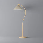 Floor lamp with pleated beige shade glowing at dusk