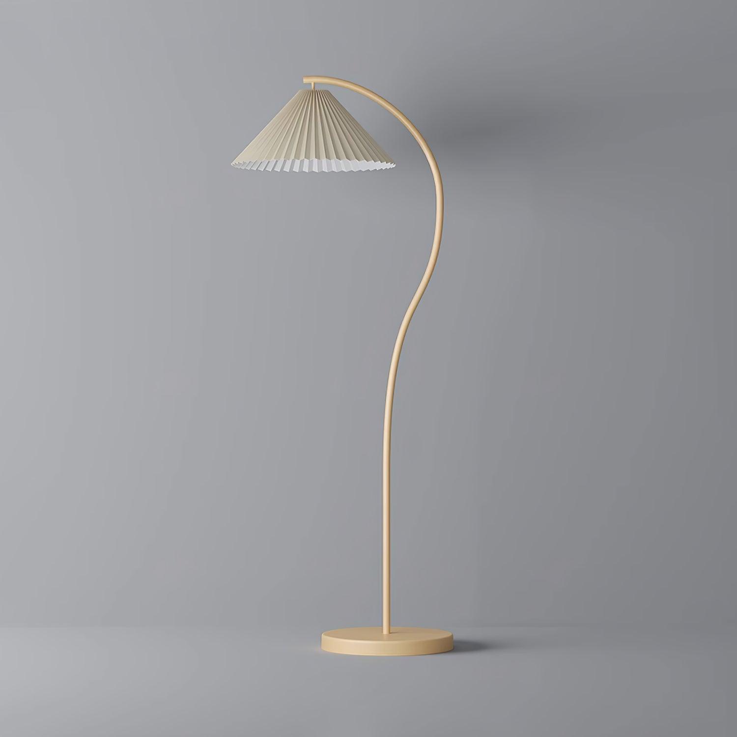 Floor lamp with pleated beige shade glowing at dusk