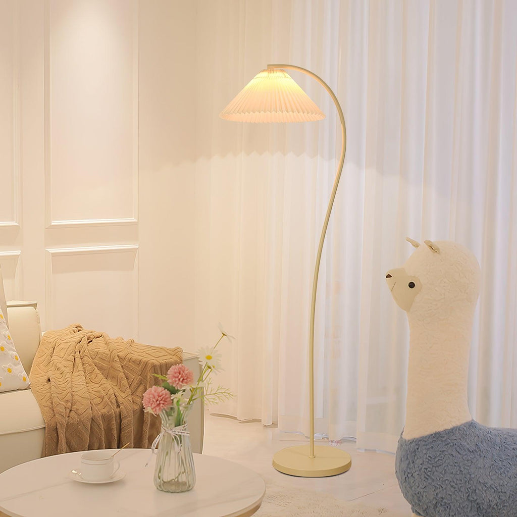 Pleated floor lamp adding soft ambience next to a reading chair