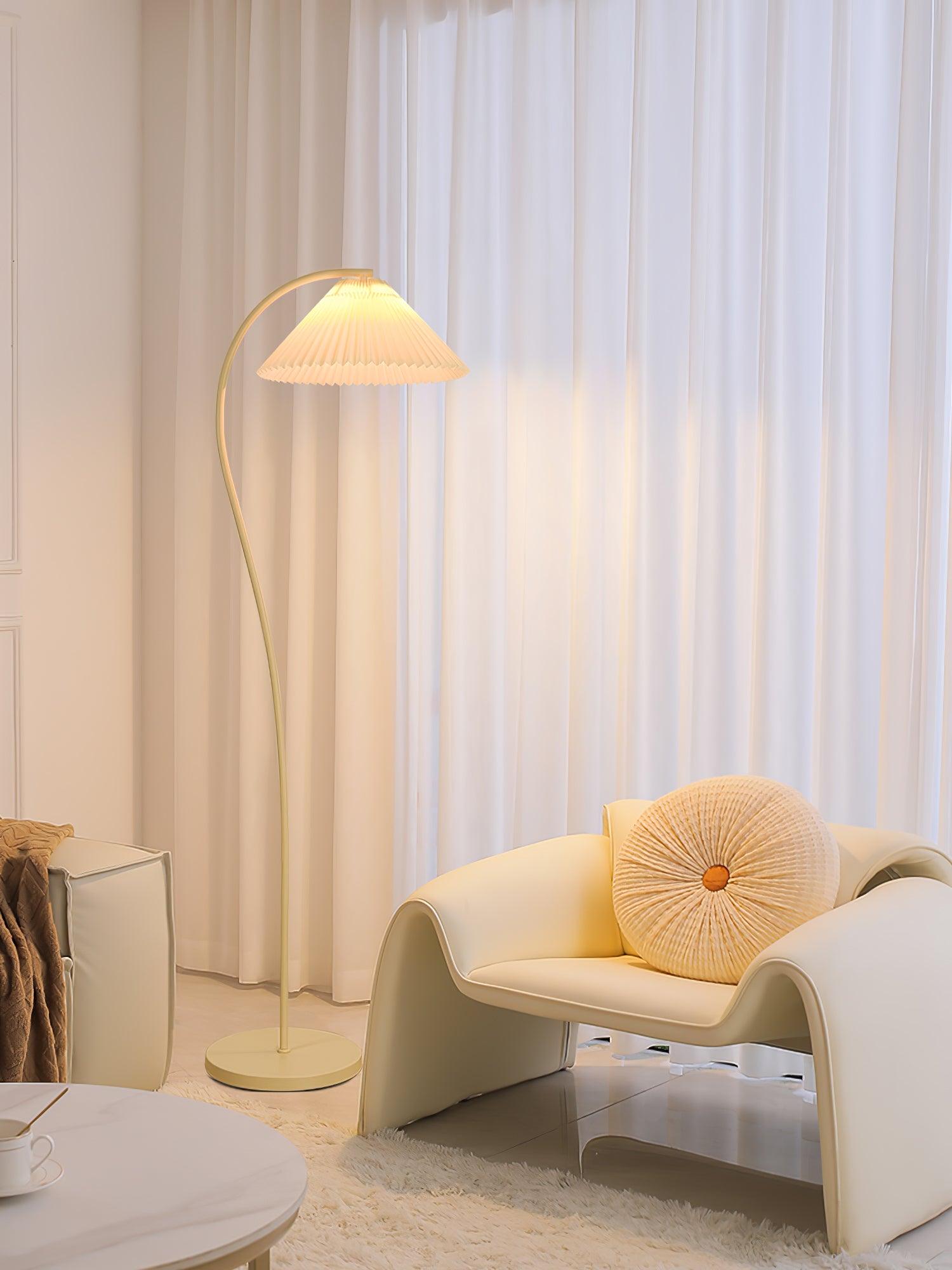 Pleated floor lamp standing against a plain wall