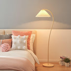 Pleated linen floor lamp lighting a corner with a beech wood frame