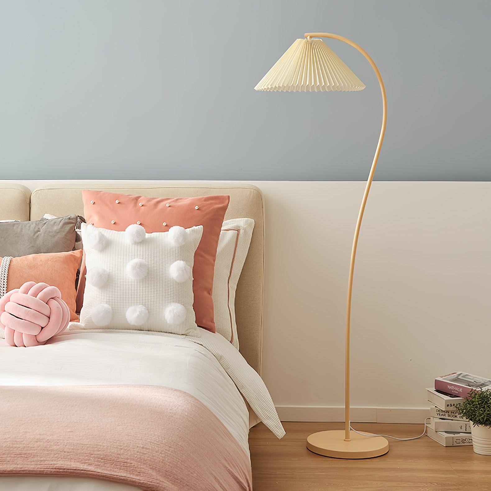 Pleated linen floor lamp lit in a warm living room scene