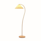 Pleated linen floor lamp glowing warmly in a home setting
