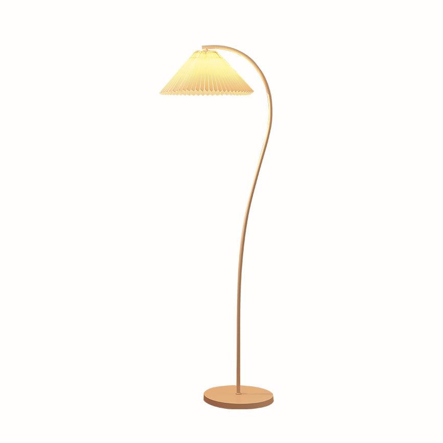 Pleated linen floor lamp glowing warmly in a home setting