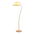 Pleated floor lamp adding gentle light to a bedroom