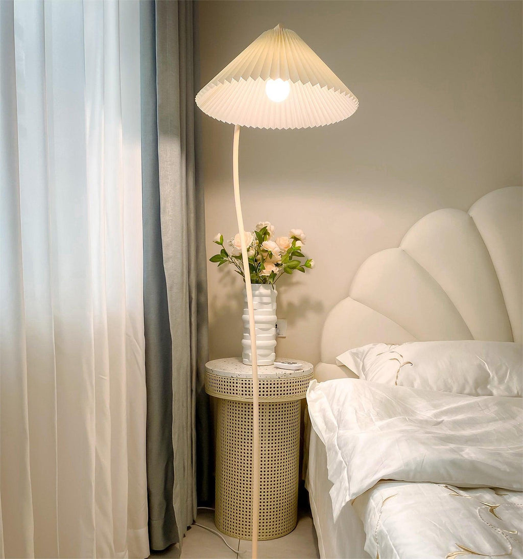 Pleated floor lamp standing in a bright, airy living room